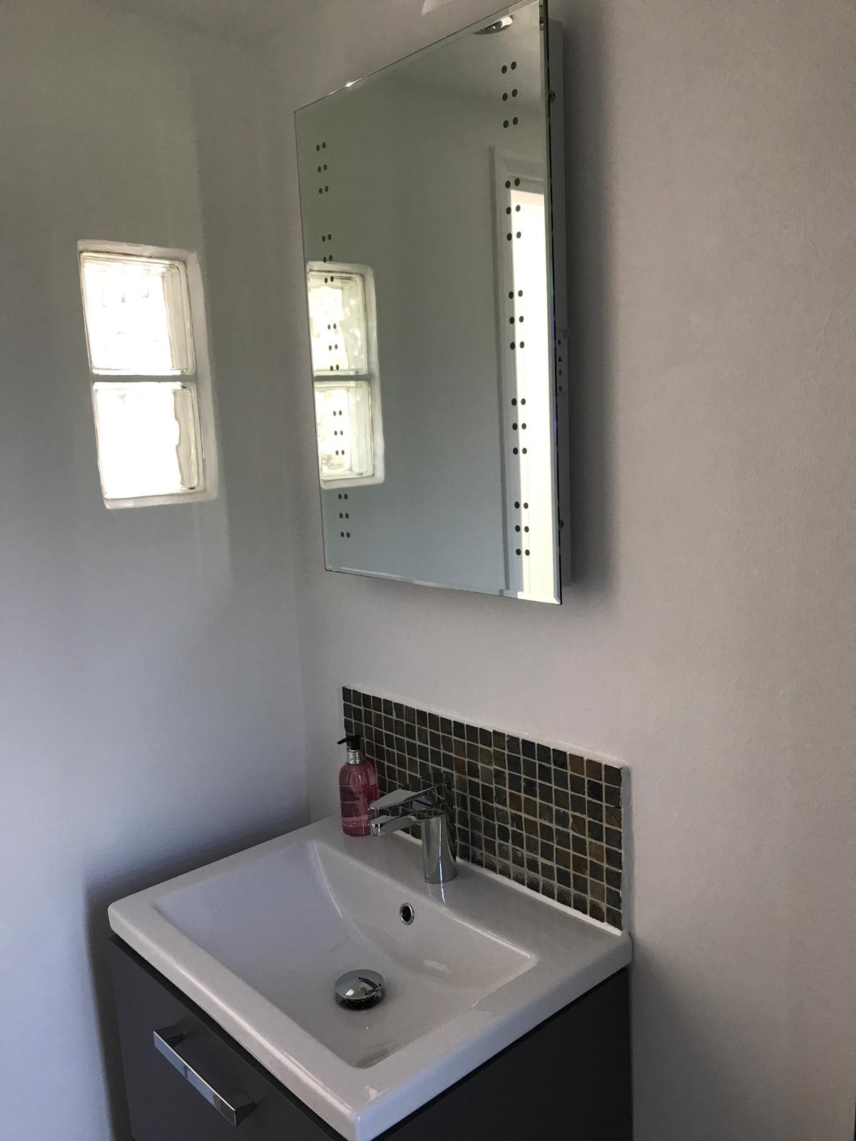 Modern bathroom with stylish vanity and mirror