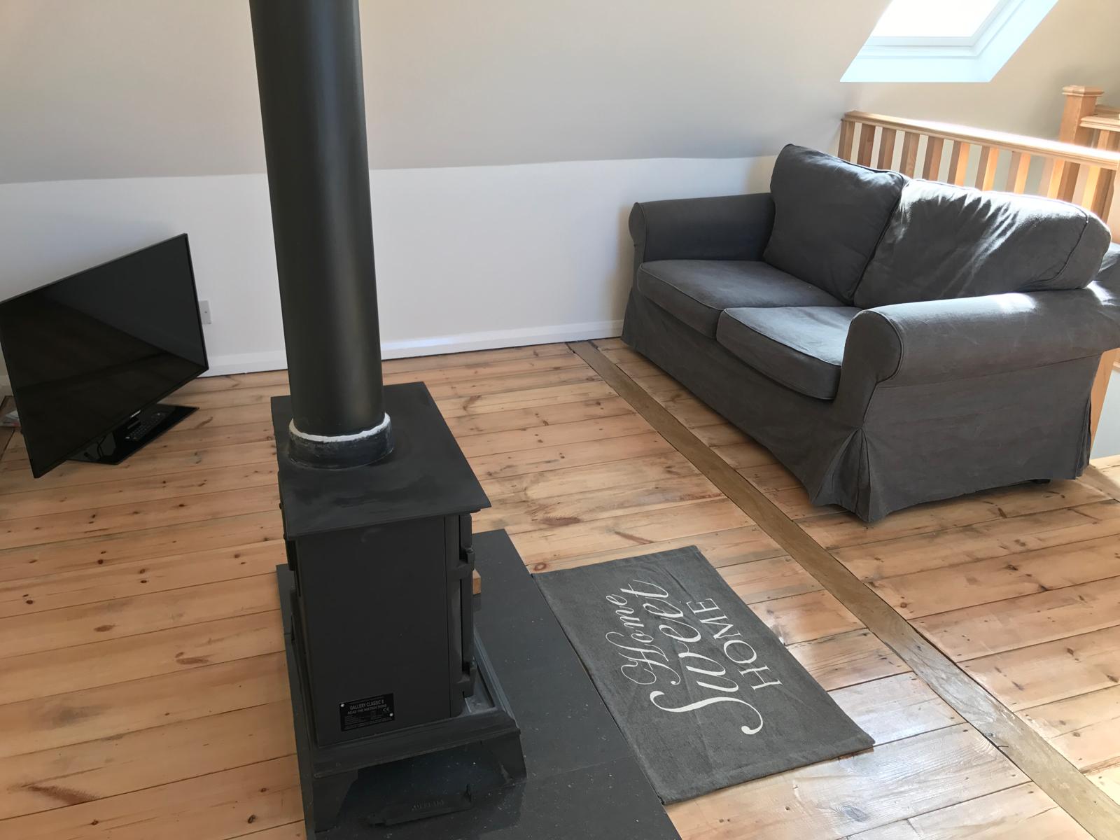 Cozy living room with traditional woodburner and comfortable seating